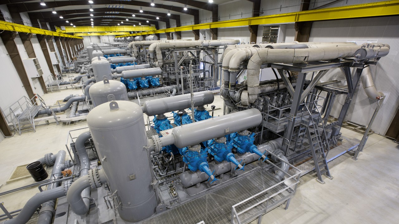 expansive view of an upstream facility featuring blue ariel compressors