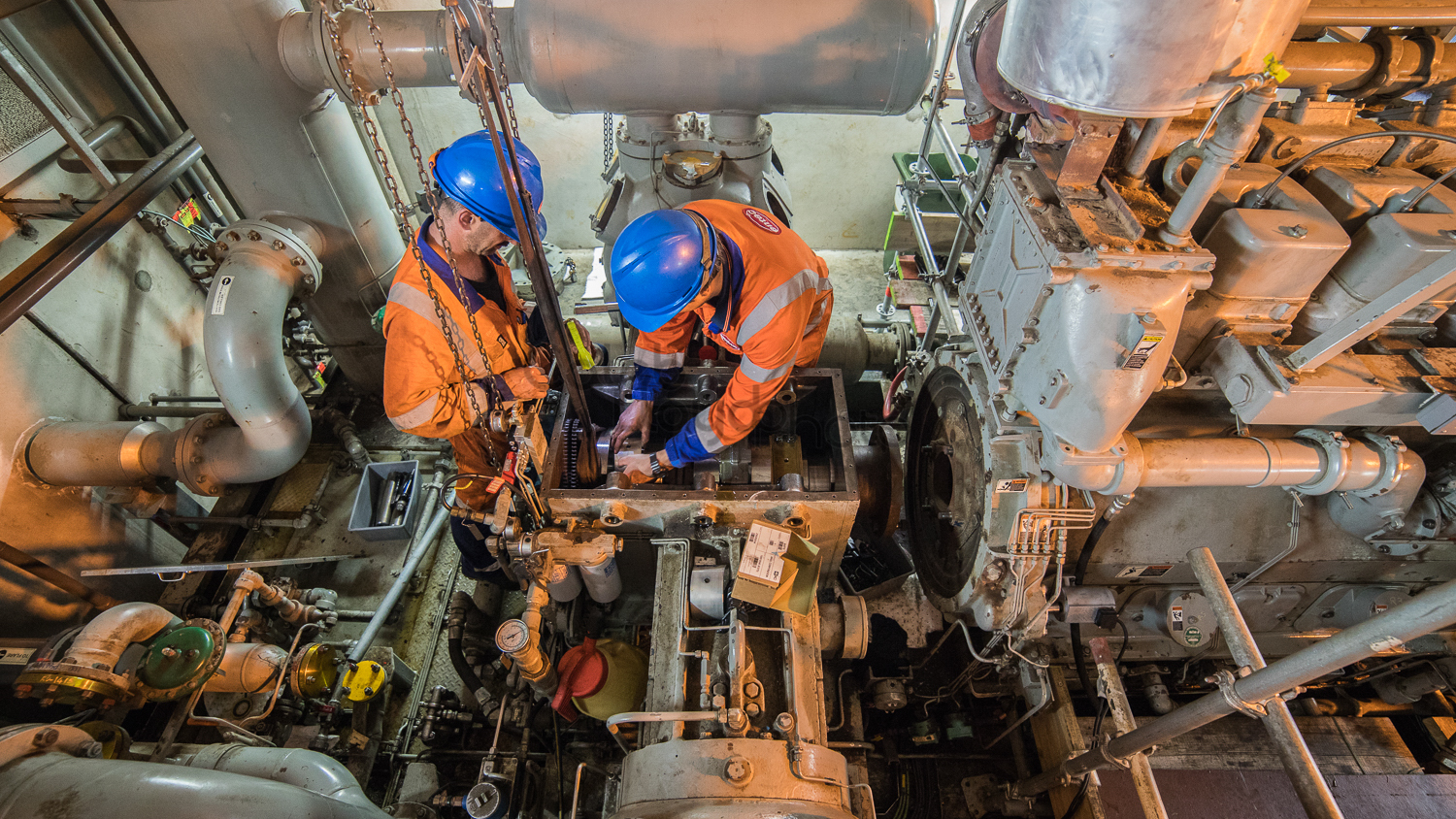 Two Entec workers work on a crankshaft