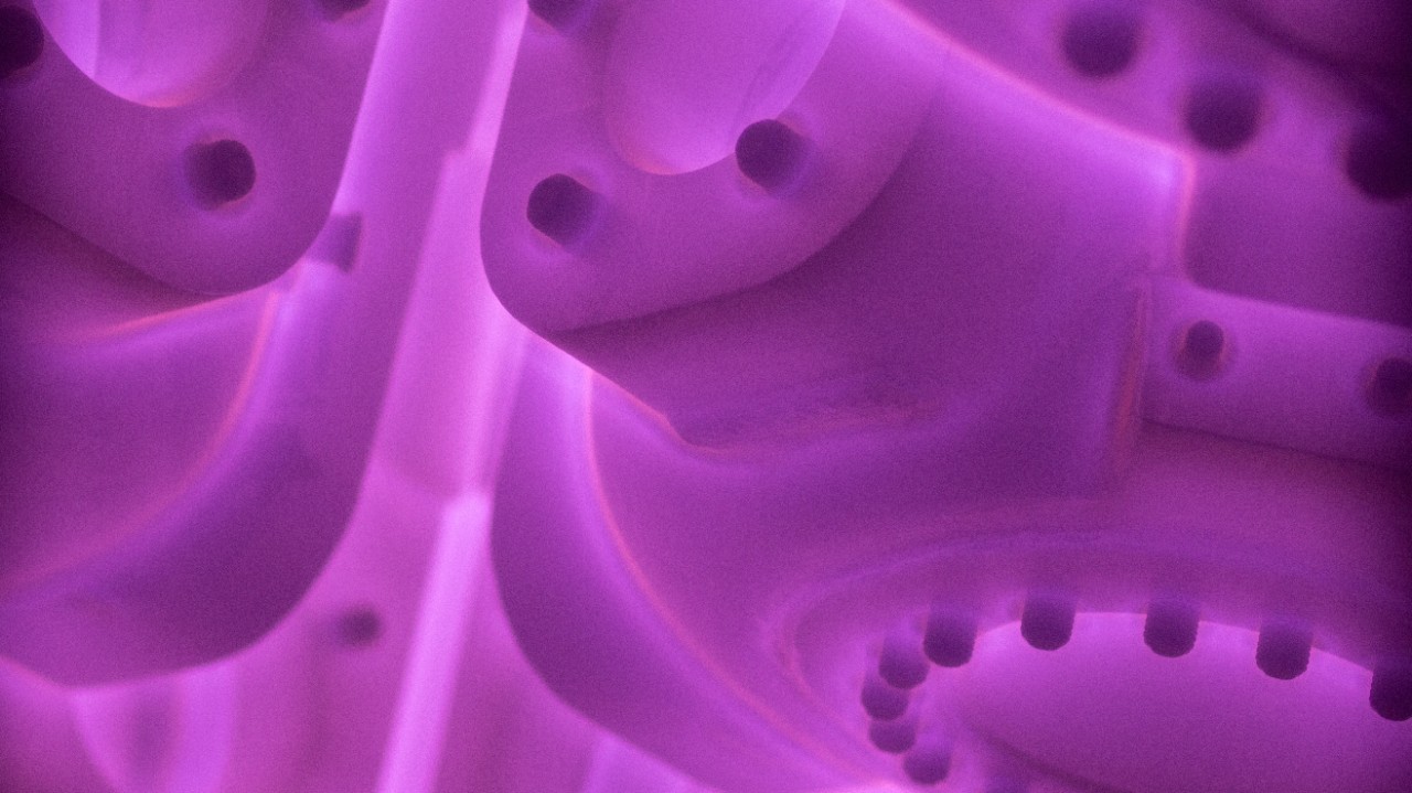 Ariel cylinders in an ion nitriding furnace appearing as purple silhouettes